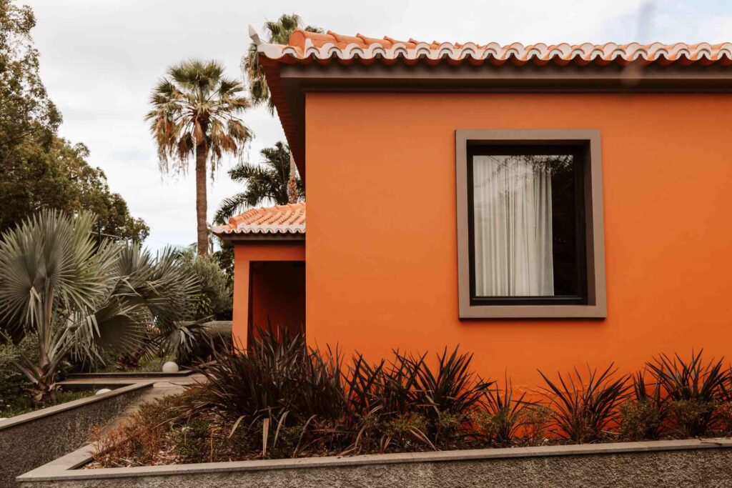 earth toned home exterior with black windows