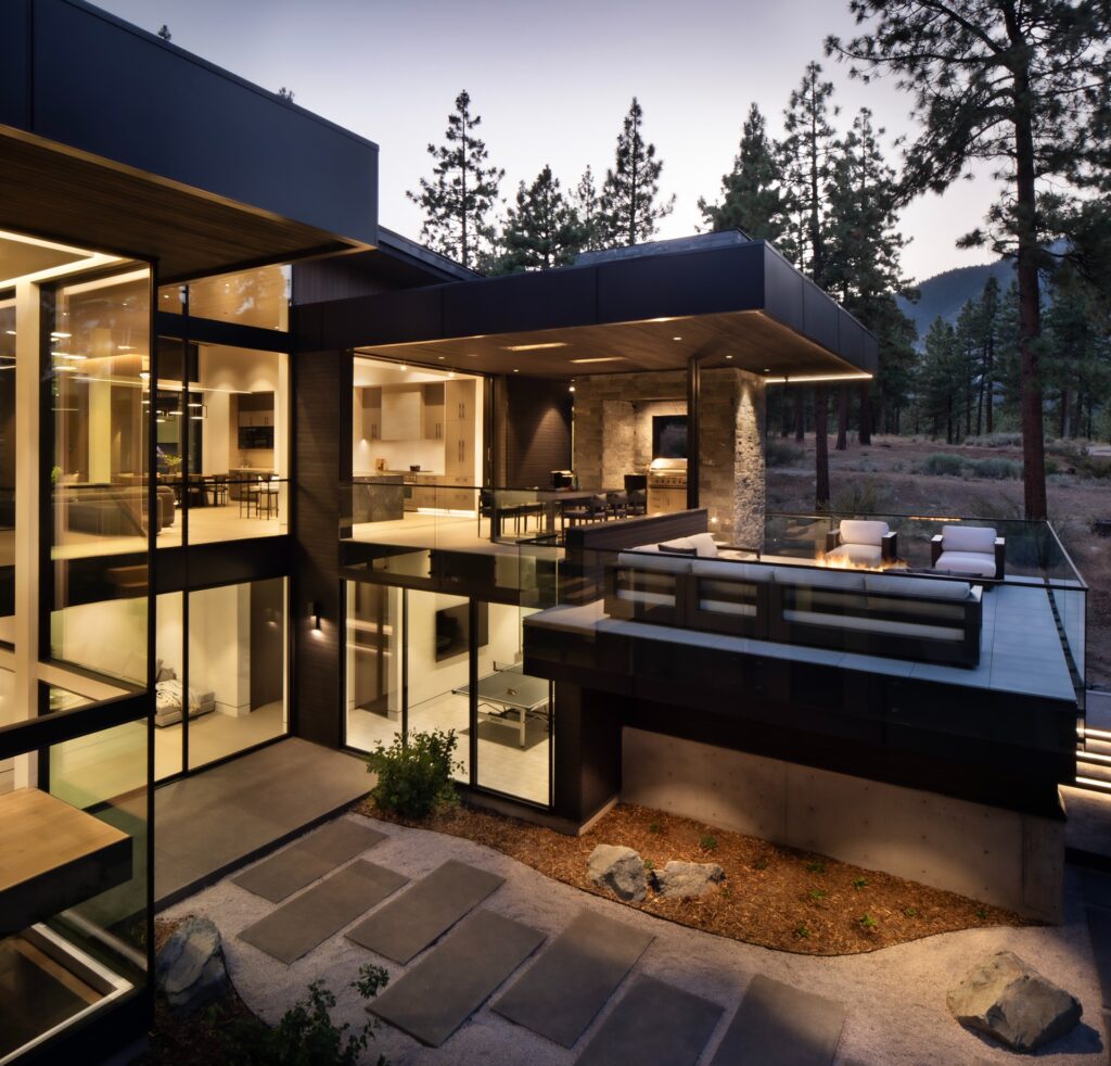modern glass home exterior dusk
