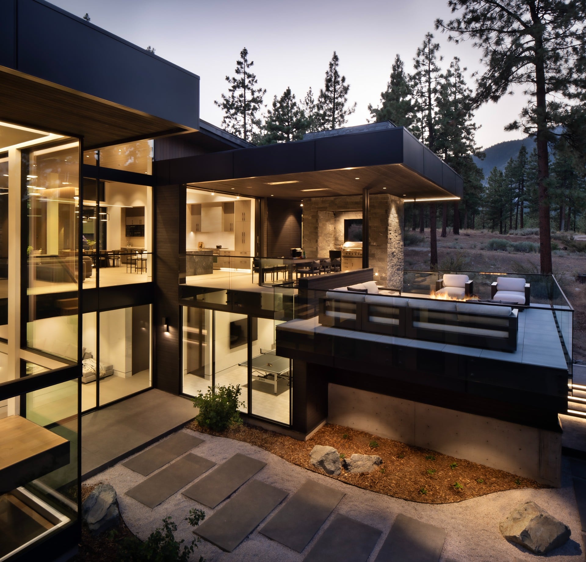 modern glass home exterior dusk